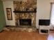 Cozy stone fireplace with wood mantel in living room at 10185 Horizon Dr, Spring Hill, FL 34608