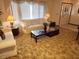 Living room with sofa and coffee table, near the entryway at 10185 Horizon Dr, Spring Hill, FL 34608