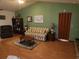 Living room with striped sofa and wood flooring at 10185 Horizon Dr, Spring Hill, FL 34608