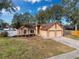 House exterior with a two-car garage and manicured lawn at 1035 Dockside Dr, Lutz, FL 33559