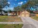 Two-car garage and nicely landscaped front yard at 1035 Dockside Dr, Lutz, FL 33559