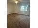 Spacious carpeted bedroom with ceiling fan and window at 108 Lakeside Dr, Oldsmar, FL 34677