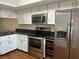Updated kitchen with stainless steel appliances and granite countertops at 108 Lakeside Dr, Oldsmar, FL 34677