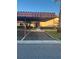 Covered parking carport with pathway to condo building entrance at 108 Lakeside Dr, Oldsmar, FL 34677