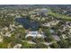 Aerial view of community with lake, pool, and tennis courts at 11030 Linkside Dr # 11030, Port Richey, FL 34668