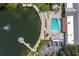 Aerial view showing pool, lake, and clubhouse at 11030 Linkside Dr # 11030, Port Richey, FL 34668
