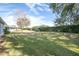 Spacious backyard with lush grass and hedges at 11030 Linkside Dr # 11030, Port Richey, FL 34668