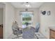 Cozy breakfast nook with a round table and four chairs, and a view of the yard at 11030 Linkside Dr # 11030, Port Richey, FL 34668
