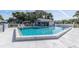 Community pool with a covered patio area at 11030 Linkside Dr # 11030, Port Richey, FL 34668