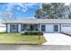Front view of a single story home with a two car garage and screened porch at 11030 Linkside Dr # 11030, Port Richey, FL 34668