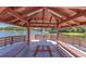 Covered lakeside gazebo with picnic table and benches at 11030 Linkside Dr # 11030, Port Richey, FL 34668