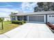 Single-story home with attached garage and landscaped front yard at 11030 Linkside Dr # 11030, Port Richey, FL 34668