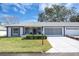 Front view of house with double garage and landscaping at 11030 Linkside Dr # 11030, Port Richey, FL 34668