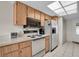 Kitchen featuring wood cabinets, stainless steel appliances and ample counter space at 11030 Linkside Dr # 11030, Port Richey, FL 34668