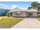 Cute bungalow with a large front yard and driveway at 13637 Lagoon Dr, Hudson, FL 34667