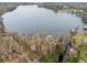 Aerial view of lakefront property with lush trees at 13721 Mill Pl, Odessa, FL 33556