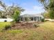 Landscaped backyard with screened pool and patio at 13721 Mill Pl, Odessa, FL 33556