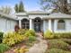Inviting front entrance with columns, lush landscaping, and a blue door at 13721 Mill Pl, Odessa, FL 33556