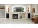 Modern fireplace with built-in shelving at 13721 Mill Pl, Odessa, FL 33556