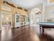 Game room with pool table, hardwood floors, and built-in shelving at 13721 Mill Pl, Odessa, FL 33556