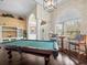 Game room featuring a pool table, built-in shelving, and hardwood floors at 13721 Mill Pl, Odessa, FL 33556