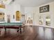 Bright game room with pool table and views to the kitchen at 13721 Mill Pl, Odessa, FL 33556