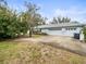 Two-car garage with driveway and landscaping at 13721 Mill Pl, Odessa, FL 33556
