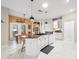 Island kitchen with white cabinets, granite countertops and breakfast bar at 13721 Mill Pl, Odessa, FL 33556