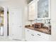 Butlers pantry with white cabinets and granite countertop at 13721 Mill Pl, Odessa, FL 33556