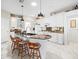 Modern kitchen featuring white cabinets, granite counters, and an island at 13721 Mill Pl, Odessa, FL 33556