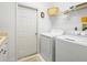 Convenient laundry room with washer, dryer, and shelving at 13721 Mill Pl, Odessa, FL 33556
