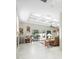 Open living room with marble flooring, a view of the pool, and access to the backyard at 13721 Mill Pl, Odessa, FL 33556