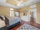 Main bedroom with king-size bed, hardwood floors, and a walk-in closet at 13721 Mill Pl, Odessa, FL 33556