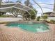 Inviting screened pool and spa with brick pavers at 13721 Mill Pl, Odessa, FL 33556