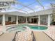Inviting pool and spa with covered patio; perfect for relaxation at 13721 Mill Pl, Odessa, FL 33556
