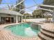 Relaxing screened pool and spa with brick pavers at 13721 Mill Pl, Odessa, FL 33556