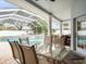 Glass-top table and chairs on patio overlooking the pool at 13721 Mill Pl, Odessa, FL 33556