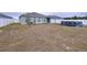 Home's backyard, featuring a spacious lawn and an above-ground pool at 14506 Whitewater Way, Brooksville, FL 34604