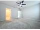 Primary bedroom with carpet and en-suite bathroom at 14506 Whitewater Way, Brooksville, FL 34604