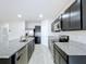 Open kitchen with island, stainless steel appliances, and granite countertops at 14506 Whitewater Way, Brooksville, FL 34604