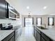 Open kitchen with island, stainless steel appliances, and granite countertops at 14506 Whitewater Way, Brooksville, FL 34604