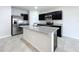 Open kitchen with island, stainless steel appliances, and granite countertops at 14506 Whitewater Way, Brooksville, FL 34604