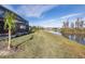 Peaceful backyard with a screened patio and lake view at 18879 Sailors Delight Pass, Land O Lakes, FL 34638