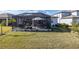 Spacious backyard with a screened patio and lush lawn at 18879 Sailors Delight Pass, Land O Lakes, FL 34638