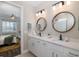 Modern bathroom with double vanity and a view into bedroom at 18879 Sailors Delight Pass, Land O Lakes, FL 34638