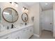 Elegant bathroom with double vanity, large mirrors, and modern fixtures at 18879 Sailors Delight Pass, Land O Lakes, FL 34638