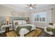 Spacious bedroom with a ceiling fan, large windows, and an ensuite bathroom at 18879 Sailors Delight Pass, Land O Lakes, FL 34638