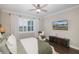 Bright bedroom with a comfy bed, large window, and mounted TV at 18879 Sailors Delight Pass, Land O Lakes, FL 34638