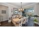 Bright dining room with a wooden table, chandelier, and view of the backyard at 18879 Sailors Delight Pass, Land O Lakes, FL 34638