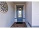 Light and bright entryway with a blue door and terracotta tile floor at 18879 Sailors Delight Pass, Land O Lakes, FL 34638